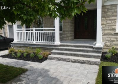 Unilock Bristol Valley front walkway with natural stone steps and flagstone landing