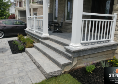 Unilock Bristol Valley front walkway with natural stone steps and flagstone landing