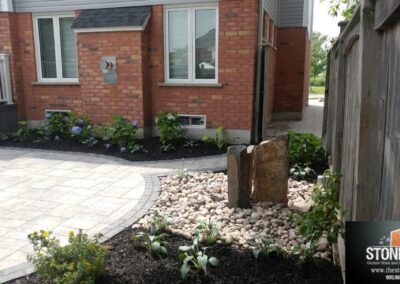 Unilock Bristol Valley back patio with basalt pondless fountain